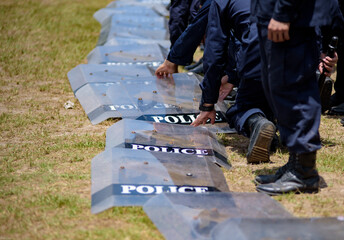 Fototapeta premium Riot police control the crowd practice and review on the grass field.