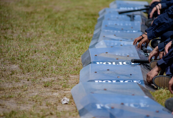 Fototapeta premium Riot police control the crowd practice and review on the grass field.