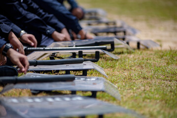 Fototapeta premium Riot police control the crowd practice and review on the grass field.