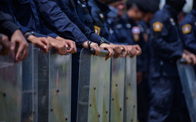 Fototapeta premium Riot police control the crowd practice and review on the grass field.