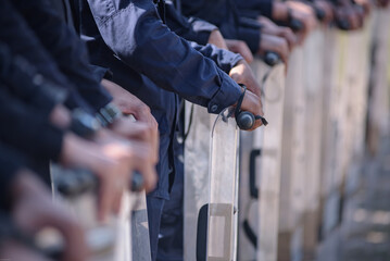Fototapeta premium Riot police control the crowd practice and review on the grass field.