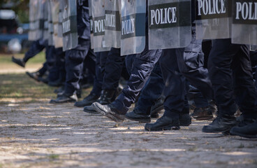 Fototapeta premium Riot police control the crowd practice and review on the grass field.