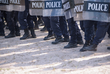 Fototapeta premium Riot police control the crowd practice and review on the grass field.