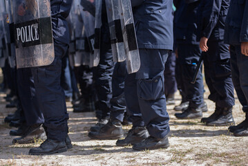 Fototapeta premium Riot police control the crowd practice and review on the grass field.