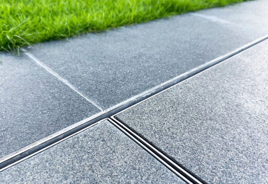 Exterior tile floor with iron gutter.