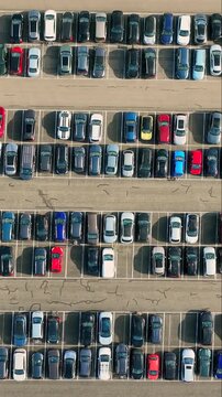 Top view of parked cars arranged in rows on a parking lot in Europe