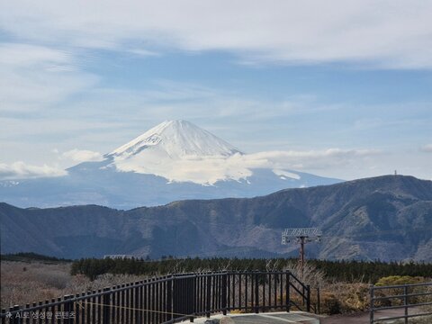 Majestic snow-capped Mount Fuji rising above clouds viewed from Hakone mountain ridge, Japan