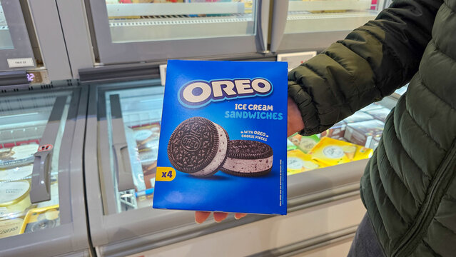 Customer shopping for a frozen dessert box in a supermarket
