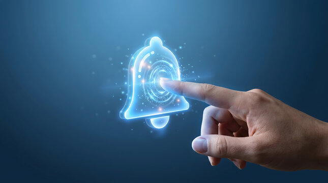 Hand tapping holographic notification bell icon representing enabling notifications or alerts in a futuristic digital interface