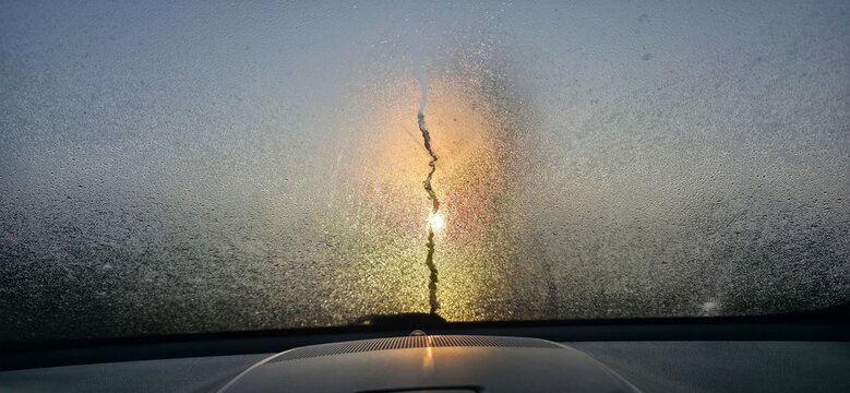 fog on the car's windshield that created a crack with water droplets
