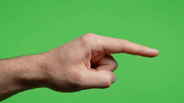 Male hand with index finger extended, pointing right on a vibrant green screen background, perfect for directional cues and compositing