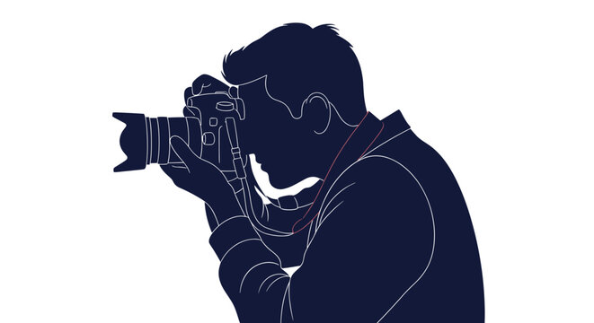 Silhouette of a professional photographer carefully focusing a high end camera to capture the perfect shot.