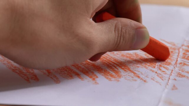 hand coloring paper with crayon