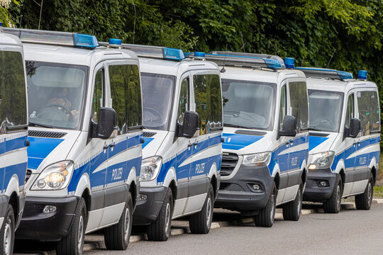 Police vehicles, squad buses, and motorcycles during a large-scale law enforcement operation.