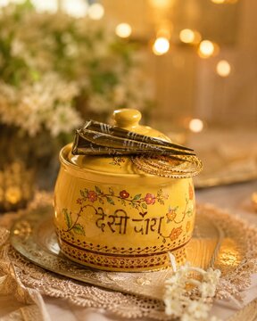 Elegant yellow desi chai decor with mehndi cones and golden bangles in a dreamy aesthetic setup.
