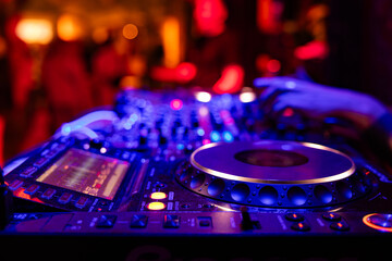Obraz premium Professional dj mixer controller with lights at nightclub party close up
