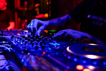 Fototapeta premium Professional dj mixer controller with lights at nightclub party close up
