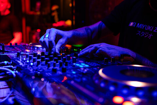 Professional dj mixer controller with lights at nightclub party close up