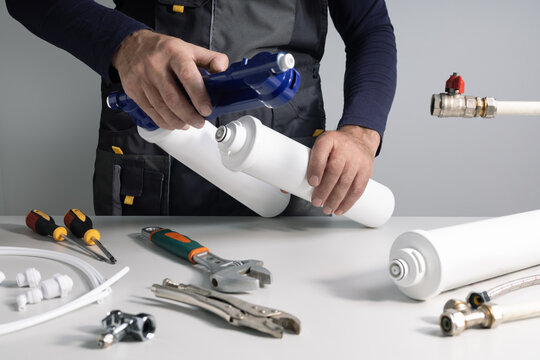 Technician installing or repairing system of water filtration.