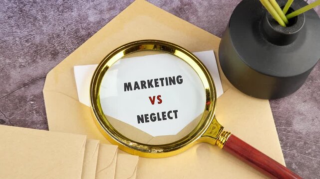 Magnifying glass reveals Marketing versus Neglect written on a white paper. A brown envelope and black vase sit nearby on a grey desk