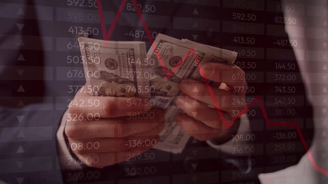 businessman counting US dollar bills with a background overlay of a falling red stock chart and negative market numbers