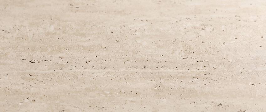 Travertine marble background shows a beige stone surface with subtle natural pits and lines