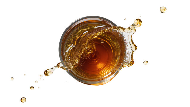 Isolated dynamic splash of amber liquid in a glass with many flying droplets, top view