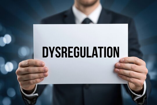 Man in a business suit holding a Dysregulation sign