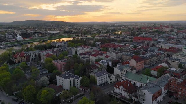 Aerial flyover of Krakow's old town at sunset in spring