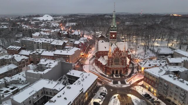 Aerial flyover of St. Joseph's Sanctuary in Krakow at sunset in winter, Poland