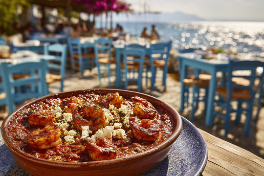 Greek shrimp saganaki with feta cheese in tavern by the sea