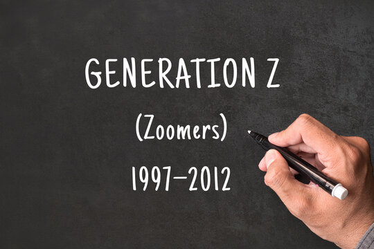 Generation Z written on blackboard with hand, Zoomers born 1997 to 2012, generational demographics and social research concept