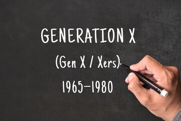 Fototapeta premium Generation X written on blackboard with hand, Gen X, Xers born 1965 to 1980, generational demographics and social research concept
