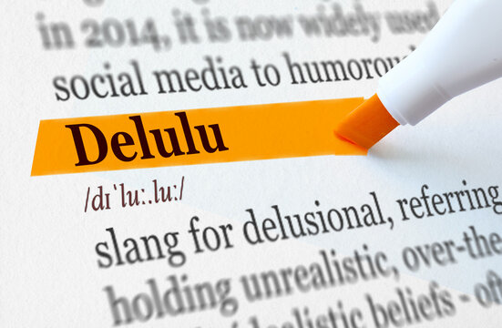 Delulu word highlighted in dictionary with marker, slang for delusional unrealistic beliefs, language trends and pop culture concept