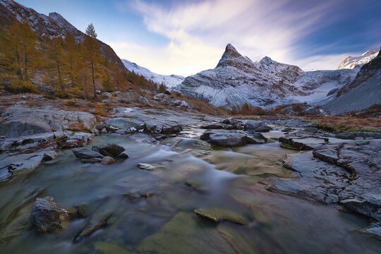 Morning atmosphere at the creek near Ferp&egrave;cle, behind it snowy Mont Min&eacute;, Val d'H&eacute;rens, Canton Valais, Switzerland