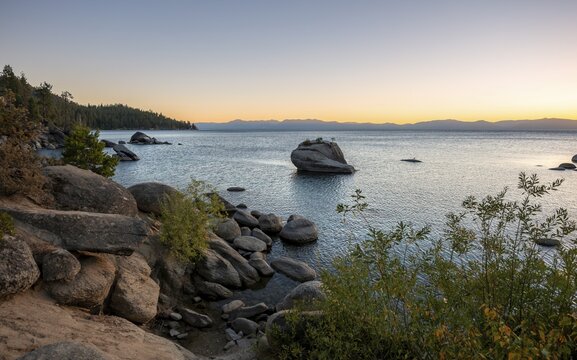 Lake shore, Bonsai Rock, small tree on a rock in the water at sunset, Lake Tahoe, California, USA