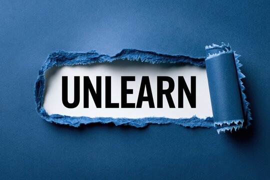 Unlearn Concept for Personal Growth Shown on Torn Paper