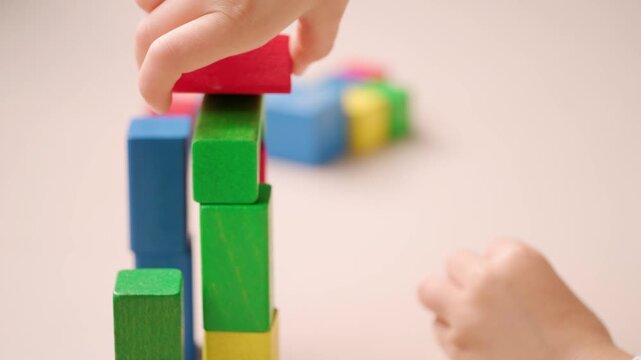 child 5 years old stacking blocks, Building castles, playing educational wooden geometric figures, childhood earlier child development, Educational play toy blocks develops motor and thinking skills