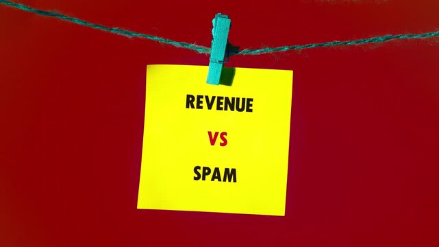Yellow sticky notes displaying Revenue versus Spam hanging on a string with blue clothespins