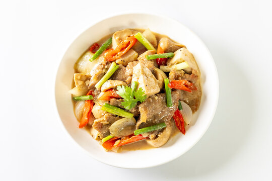 Saut&eacute; the meat in oil in a white plate on a white background.
