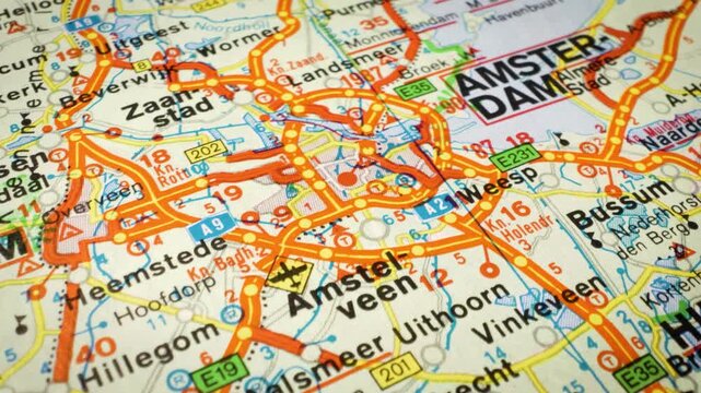 Macro glide across map showing urban road network toward Amsterdam, Netherlands