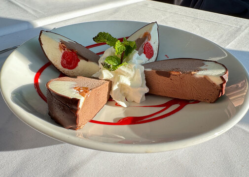 Spumoni ice cream dessert with whipped cream and mint