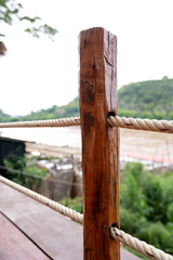 Obraz premium close up the rope tied together with a wooden pillar or fence in the restaurant and garden. Wooden art or creative concept