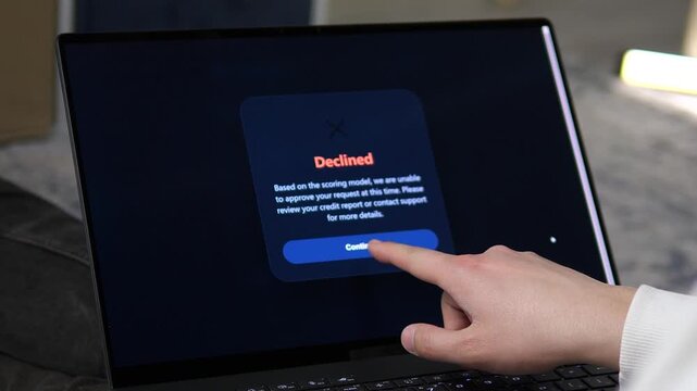 Cinematic shot of a loan application being declined on a laptop screen. Ideal for content about bad credit scores, mortgage rejection, and financial struggles. Perfect for banking and fintech-themed