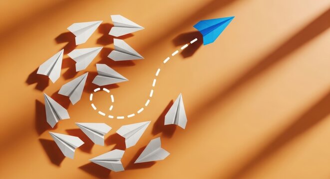 Blue paper airplane leads white paper airplanes in swirling pattern with airplane
