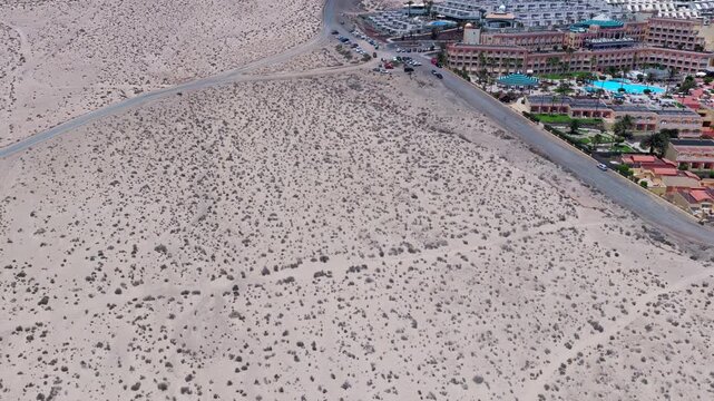 Aerial View of Hikers Trekking Across the Arid Desert Dunes of the Isthmus of La Pared, Fuerteventura