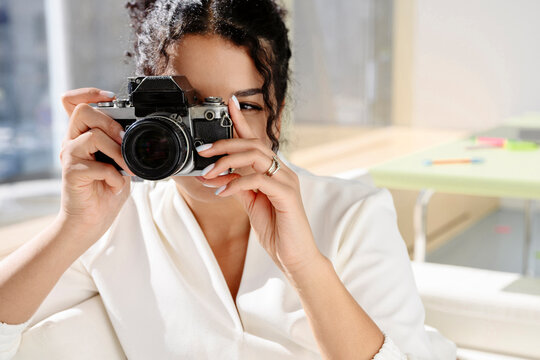 Photographer shooting with a vintage analog camera indoors