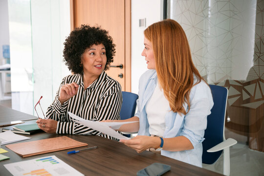 Colleagues planning together and watching charts in casual office