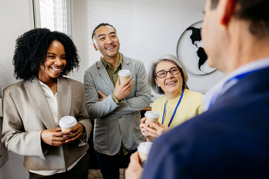 Happy businessman and businesswoman talk at the office