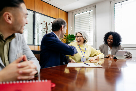Colleagues shaking hands during an office meeting